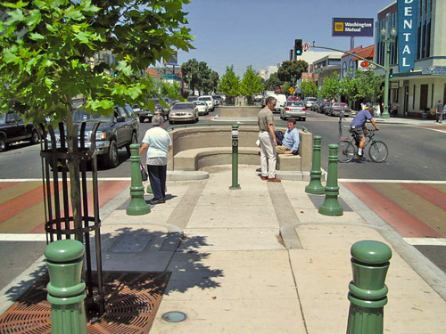 Pedestrian refuges provide space for pedestrans to wait on longer crossings and may include pedestrian amenities.